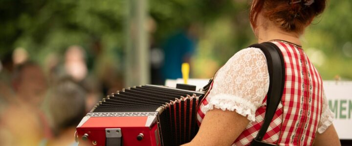 a woman in a red and white dress playing an accordion