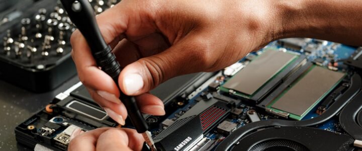 A person is working on a piece of electronics