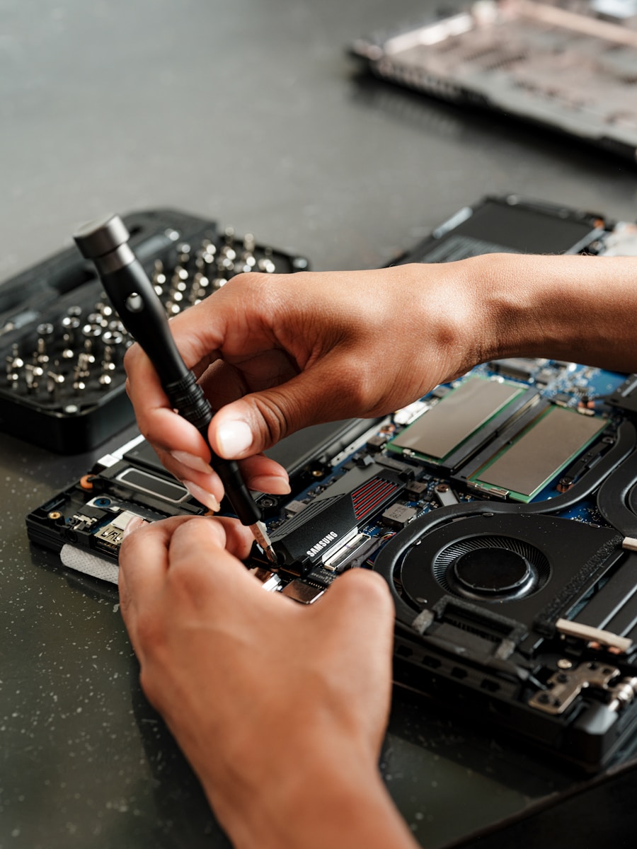 A person is working on a piece of electronics